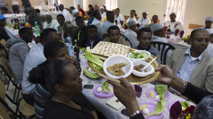 Jewish immigrants from Ethiopia attend a demonstration of a ceremonial Passover holiday dinner known as a "seder" at an immigrant's centre in Mevasseret Zion, near Jerusalem April 14, 2011. This year will be the first "seder" the immigrants will be celebrating in Israel, which begins this Monday evening. Passover commemorates the flight of Jews from ancient Egypt as described in Exodus. REUTERS/Ronen Zvulun (ISRAEL - Tags: RELIGION SOCIETY) - RTR2L7MH