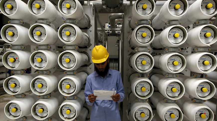 A worker stands at a desalination plant, 35 lm south of Riyadh, May 4, 2011. Long before it understood the value of oil, the desert kingdom of Saudi Arabia knew the worth of water. But the leading oil exporter's water challenges are growing as energy-intensive desalination erodes oil revenues while peak water looms more ominously than peak oil -- the theory that supplies are at or near their limit, with nowhere to go but down. Picture taken May 4, 2011. To match Feature SAUDI-WATER/ REUTERS/Fahad Shadeed   