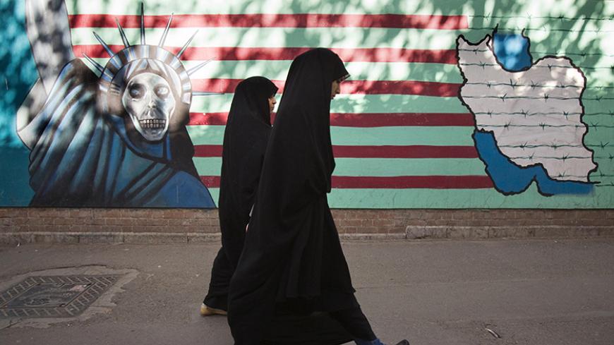 EDITORS' NOTE: Reuters and other foreign media are subject to Iranian restrictions on leaving the office to report, film or take pictures in Tehran.

Iranian women walk past an anti-U.S. mural on the wall of the former U.S. embassy in Tehran October 12, 2011. U.S. authorities said on Tuesday that they had broken up a plot by two men linked to Iran's security agencies to kill the Saudi envoy, Adel al-Jubeir. One man was arrested last month while the other was believed to be in Iran. REUTERS/Morteza Nikoubazl