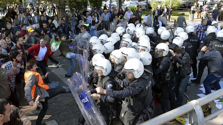 Demonstrators confront riot police following explosions during a peace march in Ankara, Turkey, October 10, 2015. At least 30 people were killed when twin explosions hit a rally of hundreds of pro-Kurdish and leftist activists outside Ankara's main train station on Saturday in what the government described as a terrorist attack, weeks ahead of an election. REUTERS/Stringer - RTS3UFC