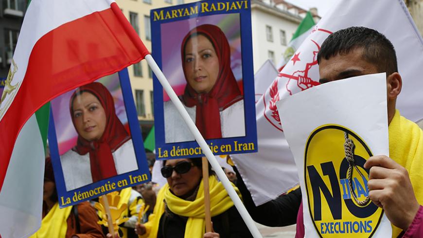 Demonstrators hold placards showing a portrait of Maryam Rajavi, President of the National Council of Resistance of Iran (NCRI), during a protest against Iran's President Hassan Rouhani in Vienna, Austria, March 30, 2016.   REUTERS/Leonhard Foeger - RTSCU95