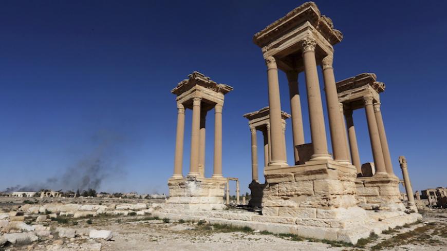 Smoke rises from the modern city as seen from the historic city of Palmyra, in Homs Governorate, Syria in this April 1, 2016 file photo. REUTERS/Omar Sanadiki/Files    - RTSD8PD