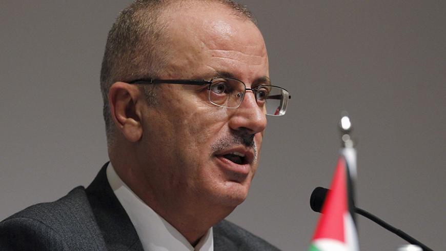 Palestinian Prime Minister Rami Hamdallah speaks to journalists during a news conference on the sidelines of the Asian African Conference in Jakarta April 21, 2015. REUTERS/Beawiharta - RTX19LQQ