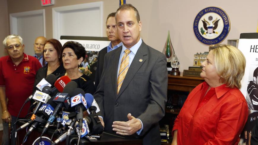 U.S. Rep. Mario Diaz-Balart (R-FL) speaks at a news conference in Miami, Florida, August 12, 2015. U.S. Rep. Ileana Ros-Lehtinen (R-FL) is seen on the right. Ros-Lehtinen called the opening of a U.S. embassy in Cuba a "diplomatic charade rewarding the tyrannical Castro regime.", local media reported. REUTERS/Joe Skipper - RTX1O2SY