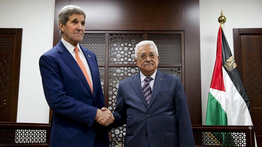 U.S. Secretary of State John Kerry (L) shakes hands with Palestinian President Mahmoud Abbas at the start of their meeting at Muqata Palace in the West Bank city of Ramallah November 24, 2015. REUTERS/Jacquelyn Martin/Pool - RTX1VMS3