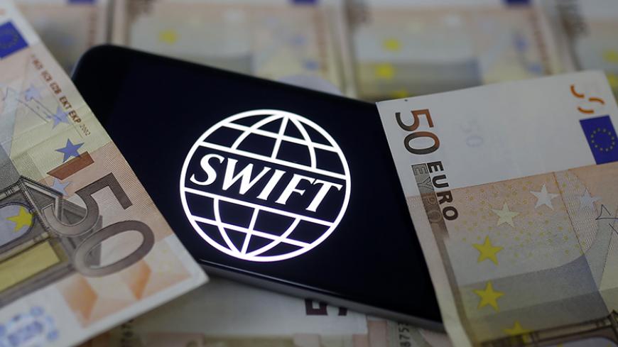 Swift code bank logo is displayed on an iPhone 6s on top of Euro banknotes in this picture illustration made in Zenica, Bosnia and Herzegovina, January 26, 2016. Picture taken January 26. Reuters/Dado Ruvic - RTX247ND