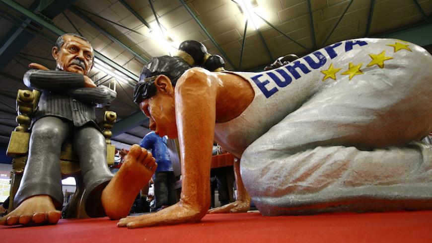 A papier mache caricature figure for a carnival float of Turkish President Tayyip Erdogan (L) is prepared for the upcoming Rose Monday carnival parade in Mainz, Germany February 2, 2016. REUTERS/Kai Pfaffenbach  - RTX252Q1
