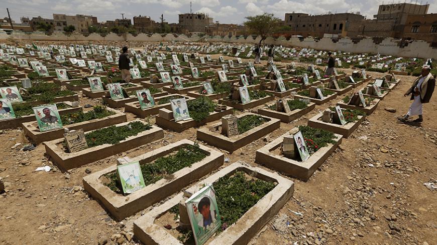 People tour a graveyard for Houthi fighters killed in recent fighting, during the first day of a ceasefire in Yemen's capital Sanaa April 11, 2016. REUTERS/Khaled Abdullah      TPX IMAGES OF THE DAY      - RTX29GQ9