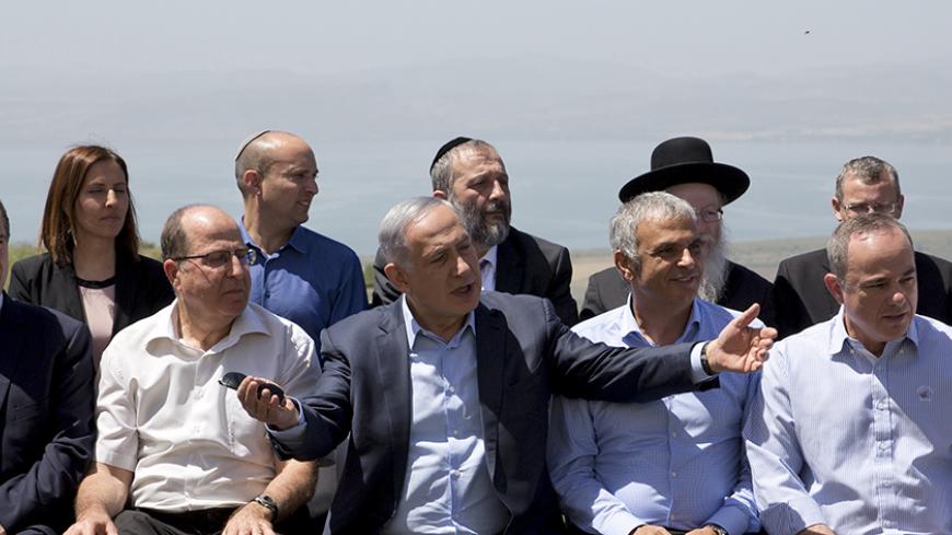 Israeli Prime Minister Benjamin Netanyahu (C front) poses with ministers prior to the weekly cabinet meeting in the Israeli occupied Golan Heights near the ceasefire line between Israel and Syria, April 17, 2016. REUTERS/Sebastian Scheiner/Pool - RTX2AB66