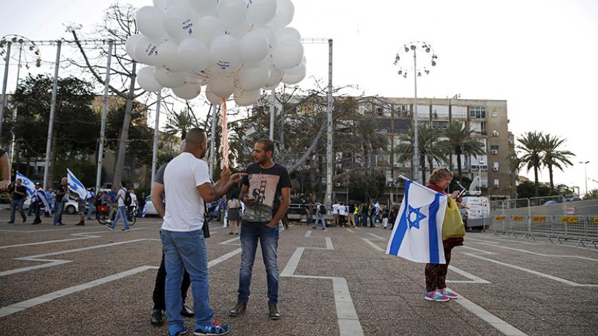 Supporters of Elor Azaria, an Israeli soldier charged with manslaughter by the Israeli military after he shot a wounded Palestinian assailant as he lay on the ground in Hebron on March 24, hold balloons before a protest calling for his release in Tel Aviv, Israel April 19, 2016. REUTERS/Baz Ratner - RTX2APM6