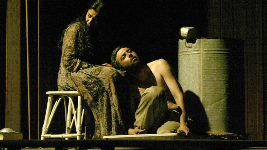 Iraqi actors perform on the stage of the damaged Rasheed theatre in Baghdad May 4, 2003, during the first post-war theatre play in the city. Members of the Najeen group performed "They passed from here", a political performance in the country's main theatre which was burned, damaged and looted during the chaotic fall of the regime of [Saddam Hussein.] - RTXLYCE