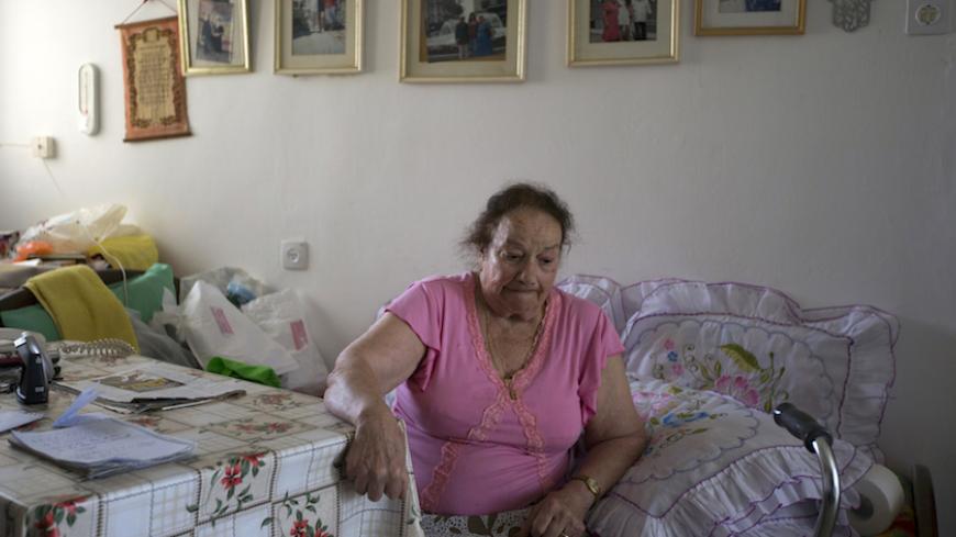 Tunisian-born Holocaust survivor Susana Peretz, 79, sits in her home in the southern city of Beersheba April 4, 2013. Some 192,000 Holocaust survivors live in Israel and about a third have sought aid from the Foundation for the Benefit of the Holocaust Victims in Israel. According to surveys by the foundation, 19 percent of the survivors have admitted to going without adequate amounts of food and 14 percent had to forego medical treatment at least once a year due to financial hardship. The report said that 