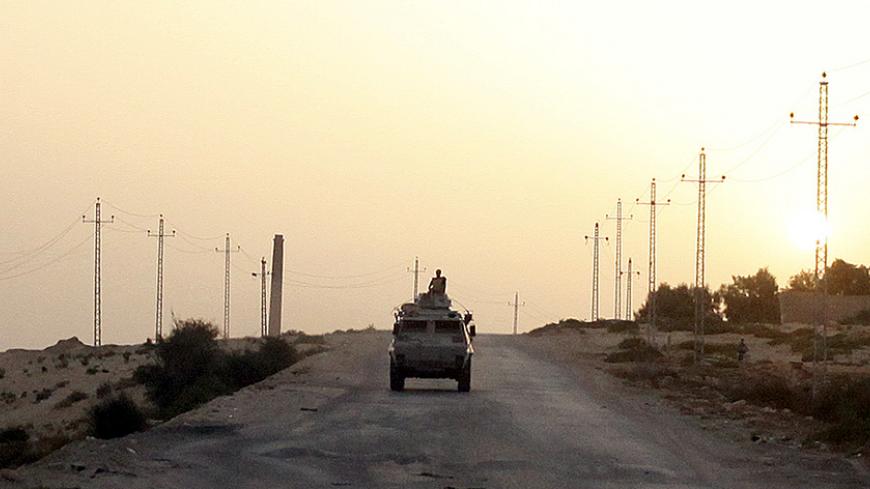 An Egyptian military vehicle is seen on the highway northern Sinai, May 25, 2015. Authorities in the Sinai Peninsula are battling insurgents who support Islamic State, the militant group that has seized parts of Iraq, Syria and Libya. The Sinai conflict, which has has displaced hundreds of Egyptians, is the biggest security challenge for President Abdel Fattah al-Sisi, who has promised to deliver stability after four years of turmoil triggered by the 2011 uprising. Picture taken May 25, 2015. REUTERS/Asmaa 