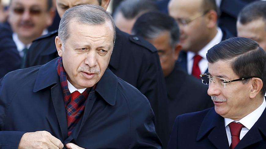 Turkey's President Tayyip Erdogan (L) chats with Prime Minister Ahmet Davutoglu during a Republic Day ceremony at Anitkabir, the mausoleum of modern Turkey's founder Ataturk, in Ankara, Turkey, October 29, 2015. Turkey marks the 92nd anniversary of the Turkish Republic. REUTERS/Umit Bektas  - RTX1TSXH