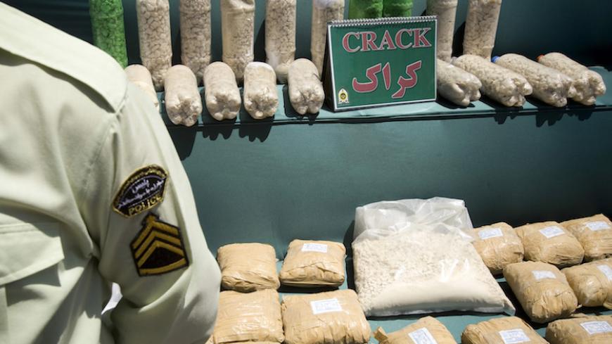 An Iranian anti-narcotics policeman stands guard beside a display of confiscated drugs during a ceremony concluding anti-narcotics manoeuvres in Zahedan, 1,605 kilometers (1,003 miles) southeast of Tehran May 20, 2009.  The head of the U.N. crime agency praised Iran during a visit on Wednesday for curbing the flow of smuggled heroin from Afghanistan and helping keep the drug off Western streets.  Picture taken May 20, 2009. REUTERS/Caren Firouz (IRAN CRIME LAW POLITICS SOCIETY) - RTXKL1B