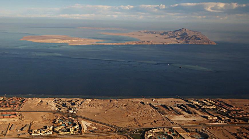 (FILE) A picture taken on January 14, 2014 through the window of an airplane shows the Red Sea's Tiran (foreground) and the Sanafir (background) islands in the Strait of Tiran between Egypt's Sinai Peninsula and Saudi Arabia.
Saudi King Salman on April 11, 2016 wrapped up a landmark five-day visit to Egypt marked by lavish praise and multi-billion-dollar investment deals, in a clear sign of support for President Abdel Fattah al-Sisi's regime. Egypt also agreed during the visit to demarcate its maritime bord