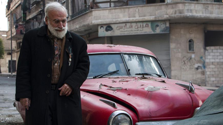 Abu Omar a 69-year-old Syrian classic car collector, stands next to one of his cars in the rebel held al-Shaar district of the northern Syrian city of Aleppo, on December 20, 2015. The ongoing five-year conflict in Syria put an end to Abu Omar's dream to exhibit his classic car collection, which he's struggling to maintain from further damage as fighting continues to riddle the country. AFP PHOTO / KARAM AL-MASRI / AFP / KARAM AL-MASRI        (Photo credit should read KARAM AL-MASRI/AFP/Getty Images)