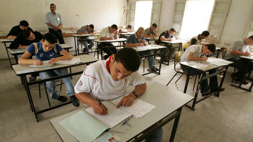 Palestinian students undergo their final exam at a school in Gaza June 11, 2007. The test began on schedule, but most pupils took circuitous routes to their schools in a bid to avoid the gunmen as the sounds of shooting punctuated the air, witnesses said. REUTERS/Mohammed Salem (GAZA) - RTR1QOYW