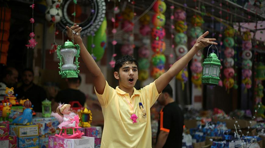 A Palestinian man sells lanterns ahead of the Muslim fasting month of Ramadan in Khan in the southern of Gaza Strip June 5, 2016. REUTERS/Ibraheem Abu Mustafa - RTSG2IG
