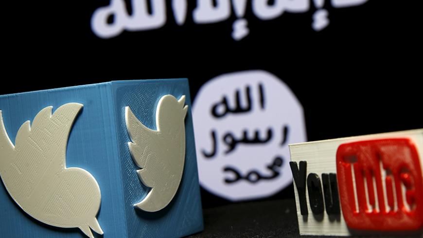 A 3D plastic representation of the Twitter and Youtube logo is seen in front of a displayed ISIS flag in this photo illustration in Zenica, Bosnia and Herzegovina, February 3, 2016. Iraq is trying to persuade satellite firms to halt Internet services in areas under Islamic State's rule, seeking to deal a major blow to the group's potent propaganda machine which relies heavily on social media to inspire its followers to wage jihad. Picture taken February 3, 2016. To match Insight MIDEAST-CRISIS/IRAQ-INTERNET