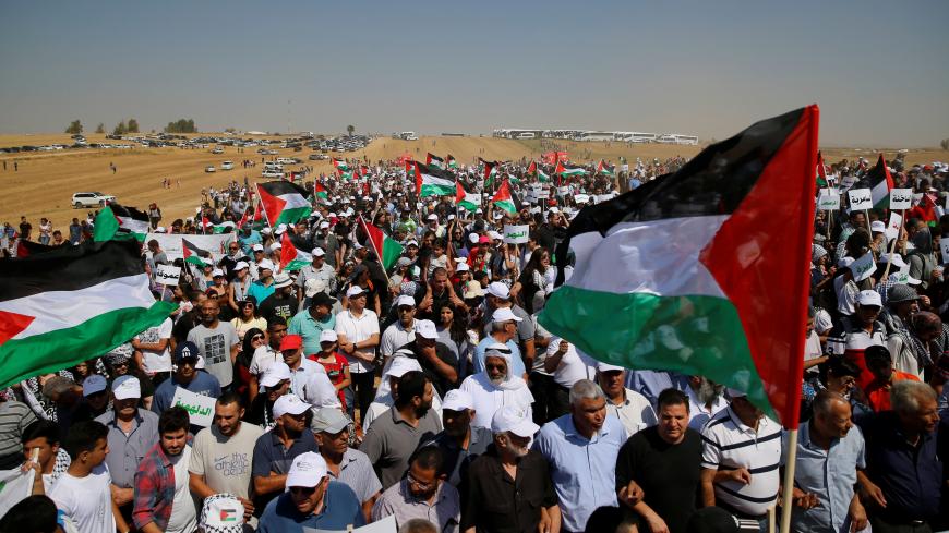 Israeli Arabs and other supporters wave Palestinian flags as they march during a protest to mark the right of return for refugees who fled their homes during the 1948 ArabÐIsraeli War, at a village near Rahat in southern Israel, May 12, 2016. The 1948 war followed the creation of Israel, which marks its 68th Independence Day this year. REUTERS/Ammar Awad - RTX2E17F