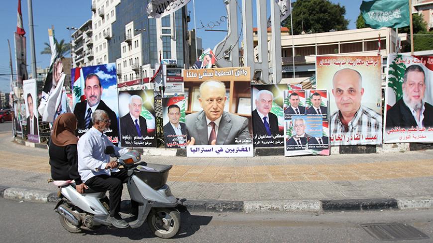 A poster depicting Sunni politician Ashraf Rifi (C) is seen among posters of Lebanese candidates that were running in Tripoli's municipal and mayoral elections, Lebanon, May 30, 2016. REUTERS/Omar Ibrahim - RTX2EV4O
