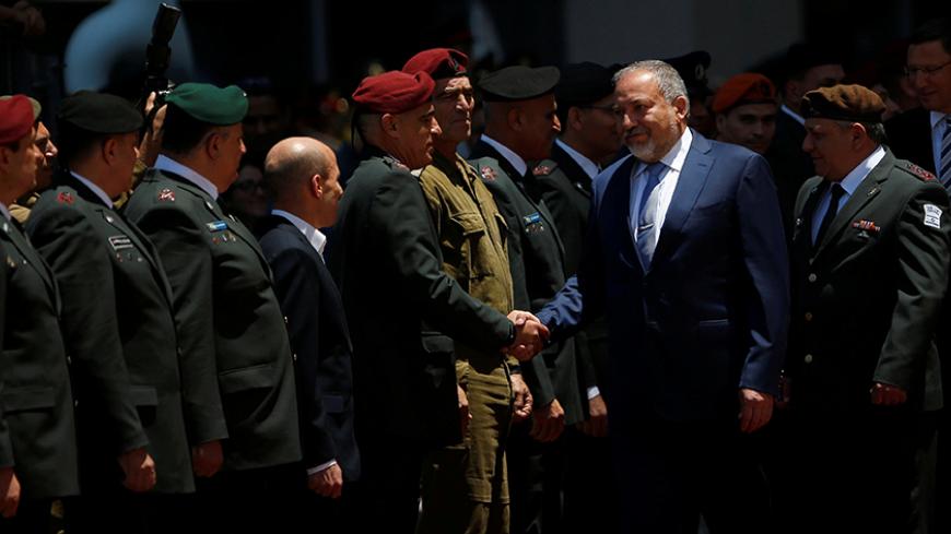 Israel's new Defence Minister, Avigdor Lieberman, head of far-right Yisrael Beitenu party, shakes hands Israeli army generals during a welcoming ceremony at the Defence Ministry in Tel Aviv, Israel May 31, 2016. REUTERS/Ronen Zvulun - RTX2EXQM
