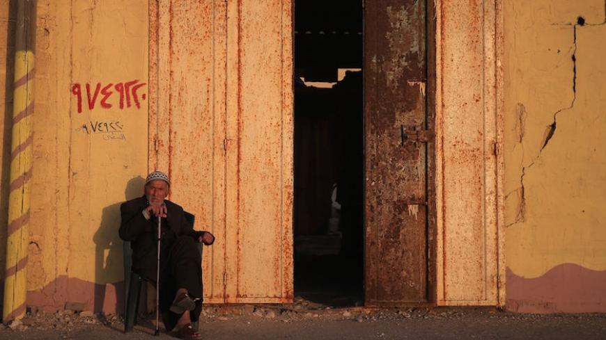 A Palestinian man sits outside his home in Gaza City on May 25, 2016. / AFP / MOHAMMED ABED        (Photo credit should read MOHAMMED ABED/AFP/Getty Images)