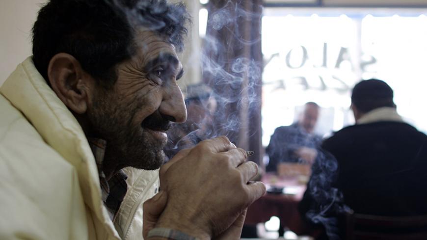 A man smokes in a cafe in Ankara January 17, 2008. Turkey is the eighth biggest cigarette market in the world, with nearly 60 percent of male adults estimated to smoke. Six global cigarette producers and state-run Tekel compete for the lucrative market. Picture taken January 17, 2008. To match feature TURKEY-CIGARETTES/     REUTERS/Umit Bektas (TURKEY) - RTR1X0MZ