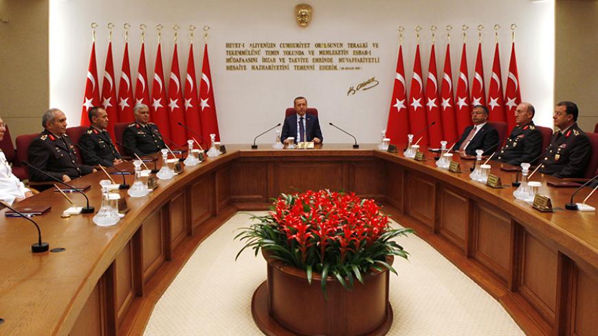 Turkey's Prime Minister Tayyip Erdogan (C) chairs the annual meeting of the Supreme Military Council (YAS) as he is flanked by Ground Forces Commander and acting Chief of Staff General Necdet Ozel (5th L), Defense Minister Ismet Yilmaz (4th R) and the other top army officers in Ankara August 1, 2011. Erdogan chaired a meeting of the military top brass on Monday, looking to restore order in NATO's second-biggest army after its top four generals quit in protest at the jailing of hundreds of officers. The long