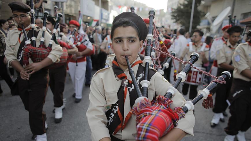 Scouts perform during a visit by Maronite Patriarch Beshara al-Rai to the West Bank town of Bethlehem May 27, 2014. Rai joined Pope Francis on his tour of the Holy Land this week, drawing criticism in Lebanon which remains in a formal state of war with its southern neighbor Israel. REUTERS/Ammar Awad (WEST BANK - Tags: RELIGION POLITICS) - RTR3R47Z