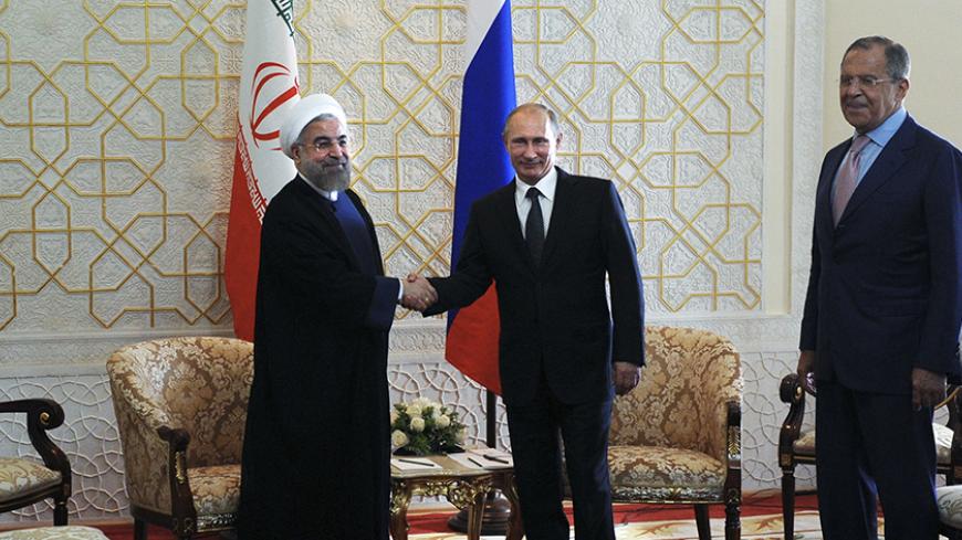 (L-R) Iran's President Hassan Rouhani, Russia's President Vladimir Putin and Russia's Foreign Minister Sergei Lavrov pose for a picture before their meeting at the Shanghai Cooperation Organization (SCO) summit in Dushanbe September 12, 2014. REUTERS/Mikhail Klimentyev/RIA Novosti/Kremlin (TAJIKISTAN - Tags: POLITICS) THIS IMAGE HAS BEEN SUPPLIED BY A THIRD PARTY. IT IS DISTRIBUTED, EXACTLY AS RECEIVED BY REUTERS, AS A SERVICE TO CLIENTS - RTR45ZQI