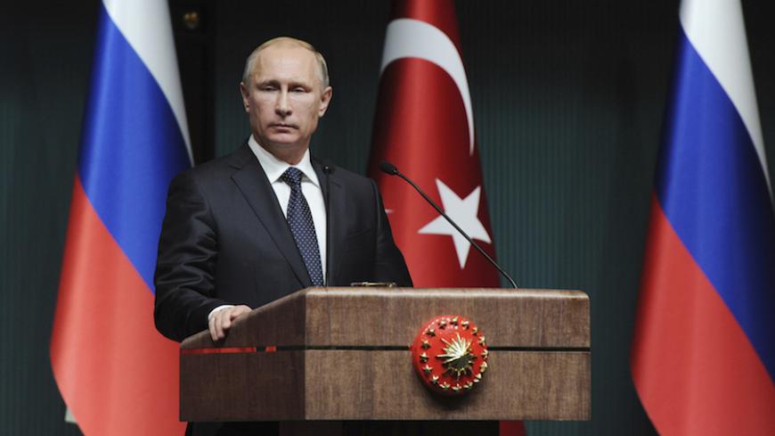 Russia's President Vladimir Putin is pictured during a joint news conference with his Turkish counterpart Tayyip Erdogan (not pictured) in Ankara December 1, 2014. Putin said on Monday that Moscow could not carry on with the South Stream project if the European Union was opposed to it. Speaking at a joint news conference with Turkish President Erdogan, Putin said the European Commission was reluctant to give the green light to the South Stream project.  REUTERS/Mikhail Klimentyev/RIA Novosti/Kremlin (TURKEY