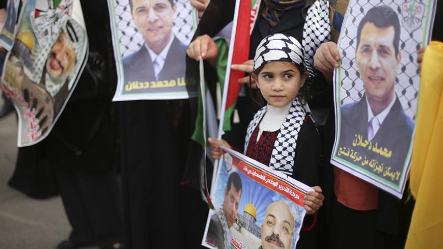 Palestinian supporters of former head of Fatah in Gaza, Mohammed Dahlan, hold posters depicting Dahlan (R) during a protest against Palestinian President Mahmoud Abbas in Gaza City December 18, 2014. Dahlan, who lives in exile in the Gulf, is a powerful political foe of Abbas. 
REUTERS/Mohammed Salem (GAZA - Tags: POLITICS CIVIL UNREST) - RTR4IJ93
