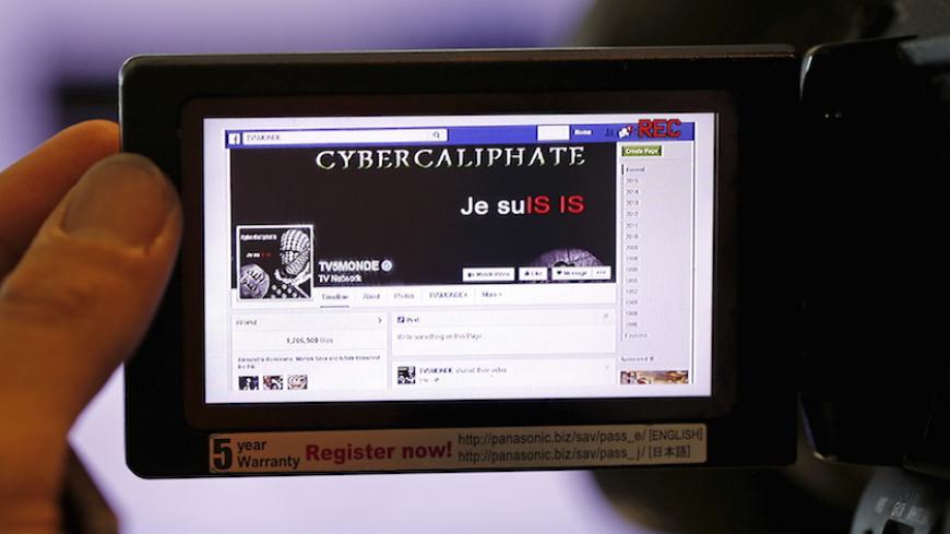A print screen of the hacked Facebook page of French television network TV5Monde is seen on a camera viewer in Paris April 9, 2015. French broadcaster TV5Monde was working on Thursday to regain control over its 11 channels and websites after an "extremely powerful" cyber attack claimed by the supporters of the Islamic State, its director said.  REUTERS/Christian Hartmann  - RTR4WLYH