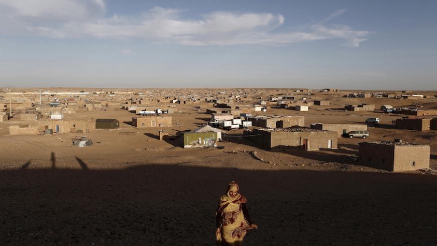 An indigenous Sahrawi woman walks at a refugee camp of Boudjdour in Tindouf, southern Algeria March 3, 2016. In refugee camps near the town of Tindouf in arid southern Algeria, conditions are hard for indigenous Sahrawi residents. Residents use car batteries for electricity at night and depend on humanitarian aid to get by. The five camps near Tindouf are home to an estimated 165,000 Sahrawi refugees from the disputed region of Western Sahara, according to the United Nations refugee agency UNHCR. REUTERS/Zo