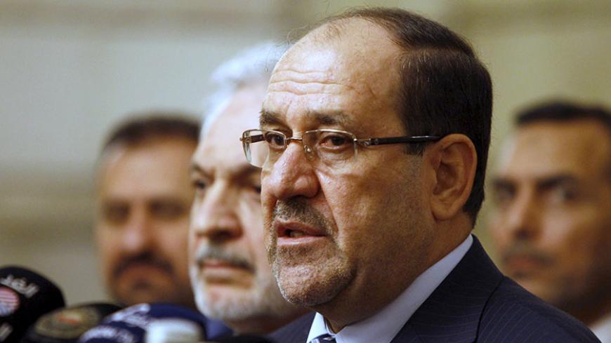 Iraq's then Vice President Nuri al-Maliki speaks during a news conference in Baghdad in this file photo taken November 29, 2014. The U.S. and Iran have formed an unlikely tacit alliance behind Iraq's prime minister as he challenges the ruling elite with plans for a non-political cabinet to fight corruption undermining the OPEC nation's economic and political stability. Local calls for Haider al-Abadi's removal -- including one by his predecessor as prime minister al-Maliki -- had been growing as he pursued 