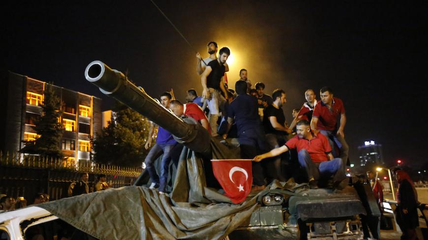 People stand on a Turkish army tank in Ankara, Turkey July 16, 2016.   REUTERS/Tumay Berkin - RTSI7T9