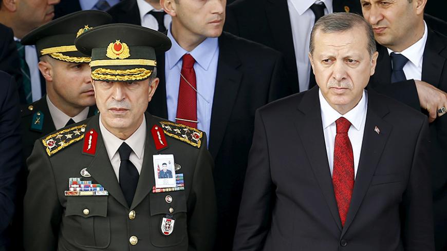 Turkish President Tayyip Erdogan (R) and Chief of Staff General Hulusi Akar attend a funeral ceremony for Army officer Seckin Cil in Ankara, Turkey, February 18, 2016. REUTERS/Umit Bektas/File Photo - RTSI8ML