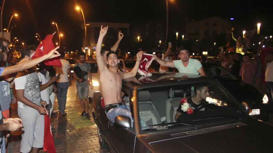 Supporters of Turkish President Tayyip Erdogan celebrate after troops involved in the coup surrendered, in the resort town of Marmaris, Turkey July 16, 2016. REUTERS/Kenan Gurbuz - RTSI8RT