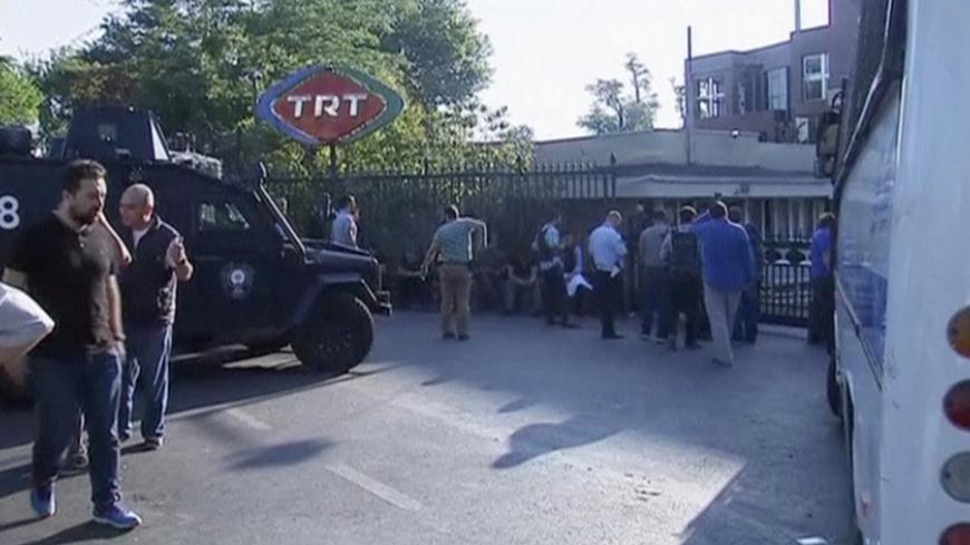 A still image from video shows armoured police vehicle and people waiting outside TRT state television after a failed coup attempt by Turkish soldiers, in Istanbul, Turkey July 16, 2016.   REUTERS/via Reuters TV - RTSI8WB
