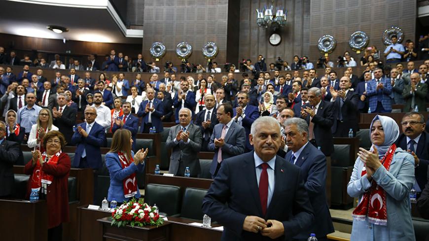 Turkey's Prime Minister Binali Yildrim (front) makes his way to address members of parliament from his ruling AK Party (AKP) during a meeting at the Turkish parliament in Ankara, Turkey July 19, 2016.    REUTERS/Umit Bektas  - RTSINN5