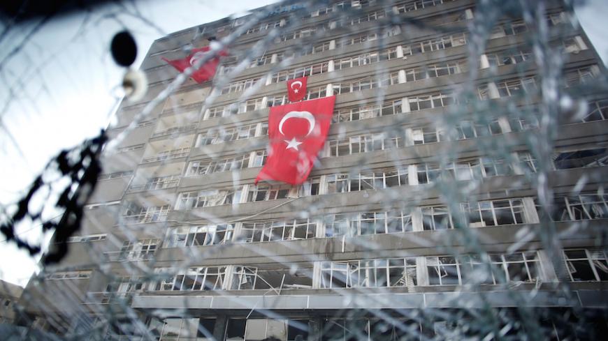 The Ankara police headquarters is seen through a car's broken window caused by fighting during a coup attempt in Ankara, Turkey, July 19, 2016. REUTERS/Baz Ratner     TPX IMAGES OF THE DAY      - RTSIQPK