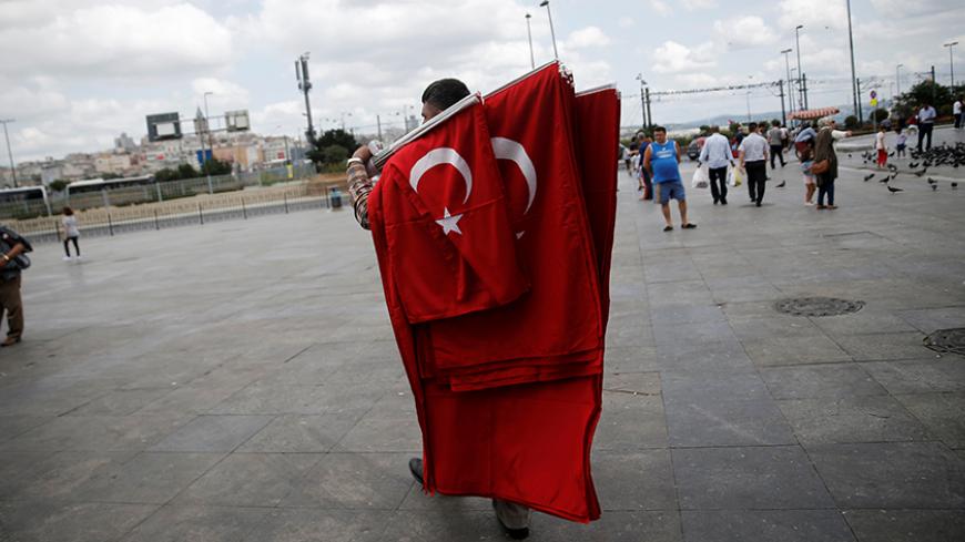A street vendor sells Turkish flags at Eminonu district in Istanbul, Turkey, July 18, 2016. REUTERS/Alkis Konstantinidis/File Photo - RTSIV9F