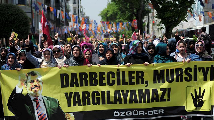 Pro-Islamist demonstrators hold a banner that reads "Coup leaders can't trial Mursi" during a protest in support former President Mohamed Mursi at the courtyard of Fatih mosque in Istanbul, Turkey, May 17, 2015. An Egyptian court on Saturday sought the death penalty for former president Mohamed Mursi and 106 supporters of his Muslim Brotherhood in connection with a mass jail break in 2011. Mursi and his fellow defendants, including top Brotherhood leader Mohamed Badie, were convicted for killing and kidnapp