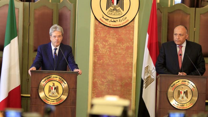 Italian Foreign Minister Paolo Gentiloni (L) listens during a news conference with his Egyptian counterpart Sameh Shoukry at the foreign ministry in Cairo, Egypt, July 13, 2015. The visit comes two days after Islamic State claimed responsibility for a car bomb attack at the Italian consulate in central Cairo on Saturday, in an escalation of violence that suggests militants are opening a new front against foreigners in Egypt. REUTERS/Mohamed Abd El Ghany - RTX1K80W