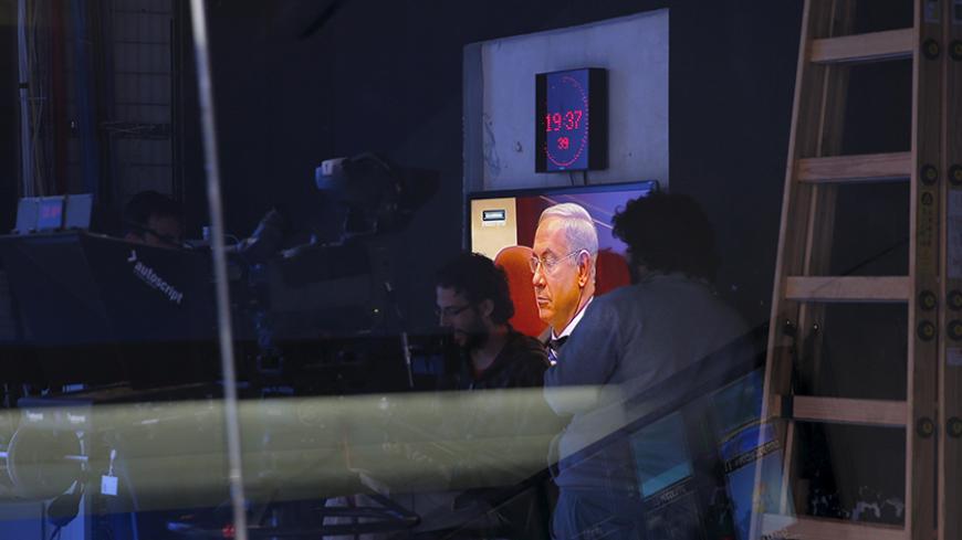 Israel's Prime Minister Benjamin Netanyahu is seen on a monitor before the evening news bulletin at Channel 10 in Jerusalem November 18, 2015. Critics say Netanyahu, known as "Bibi," is hitting the wrong note when it comes to the media, weakening press freedom and holding sway over TV broadcasters in a country that bills itself as the Middle East's only true democracy. Picture taken November 18, 2015. To match Insight ISRAEL-NETANYAHU/MEDIA REUTERS/Ronen Zvulun - RTX1VG4V