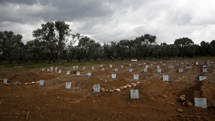 Graves of unidentified refugees and migrants who drowned at sea during an attempt to cross a part of the Aegean Sea from the Turkish coast are seen at a cemetery near the village Kato Tritos on the Greek island of Lesbos, February 4, 2016. Picture taken February 4, 2016. REUTERS/Giorgos Moutafis - RTX26UW1