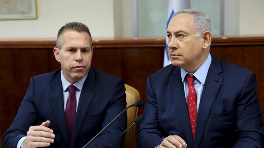 Israeli Prime Minister Benjamin Netanyahu (R) sits next to Israeli Public security Minister Gilad Erdan during the weekly cabinet meeting in Jerusalem April 10, 2016. REUTERS/Gali Tibbon/Pool  - RTX29ADY