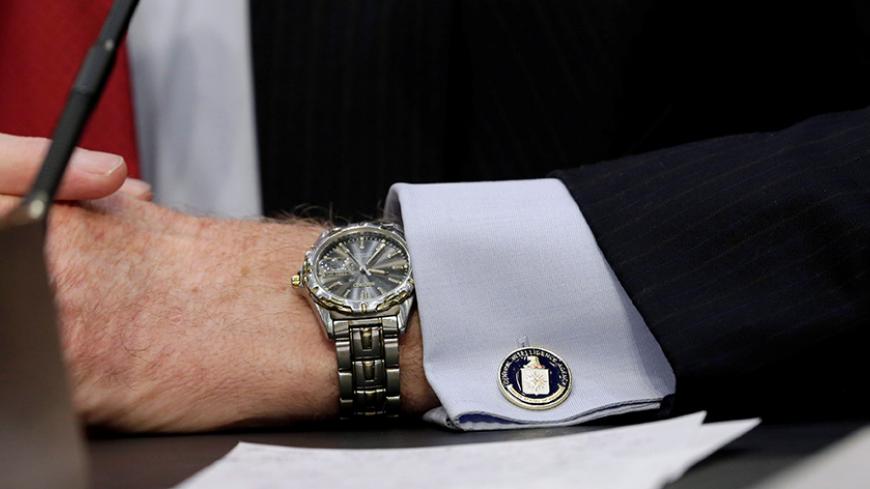 An cufflink with CIA logo is seen on CIA Director John Brennan's shirt as he testifies before the Senate Intelligence Committee hearing on "diverse mission requirements in support of our National Security", in Washington, U.S., June 16, 2016. REUTERS/Yuri Gripas - RTX2GKTP